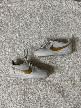 Nike White Leather Sneakers with Gold Swoosh